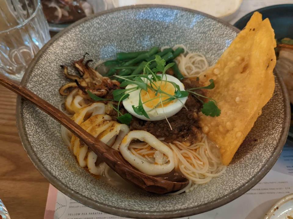 This unqiue dish mixes seafood, lemongrass, fermented fish pate, noodles, broth and a boiled egg (Emma Henderson)