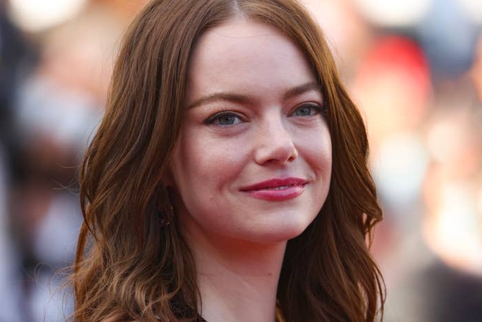 Emma Stone with long, wavy hair and a natural makeup look