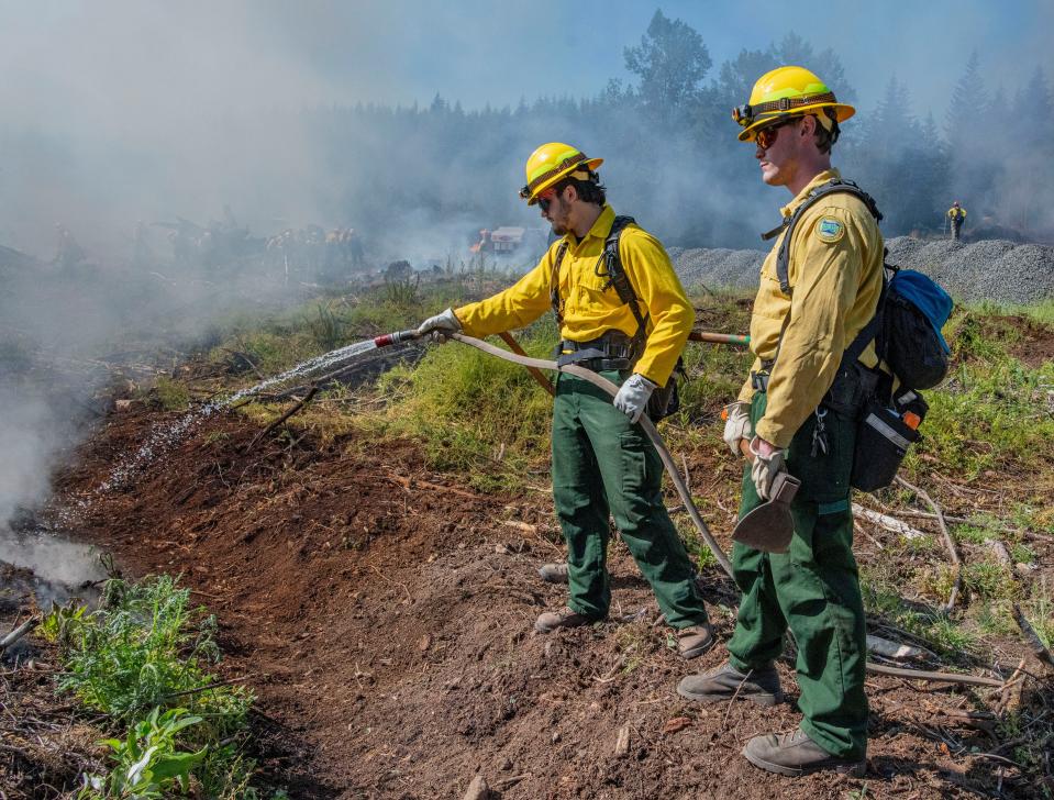 Cole Sampson, left, and Nolan Soule mop up hot spots during a live fire training outside of Sweet Home on June 28.
