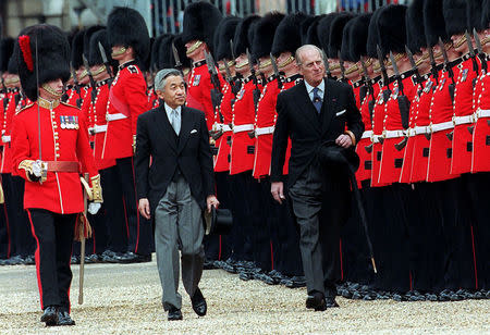 FILE PHOTO: Emperor Akihito of Japan inspects the Guard of Honour of the 1st Battalion Coldstream Guards with Britain's Duke of Edinburgh, May 26, 1998. REUTERS/Stringer/File Photo