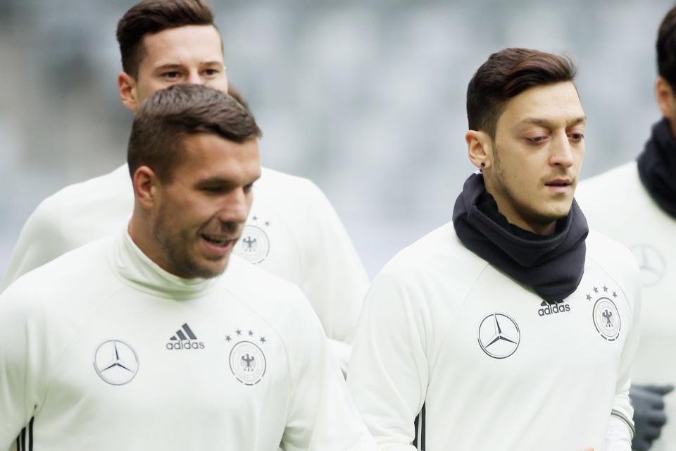 <p>Lukas Podolski and Mesut Ozil are former team-mates with both Arsenal and Germany</p> (Bongarts/Getty Images)