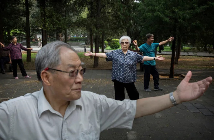 Elderly Chinese people perform tai-chi while exercising at Ritan Park on June 10, 2016 in Beijing, China.