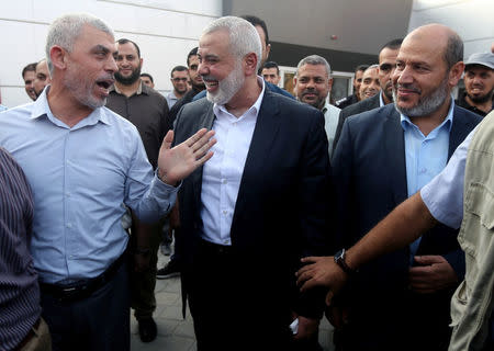 Hamas Gaza Chief Yehya Al-Sinwar (L) gestures as he speaks with Hamas chief Ismail Haniyeh at the Rafah border crossing in the southern Gaza Strip September 19, 2017. REUTERS/Ibraheem Abu Mustafa