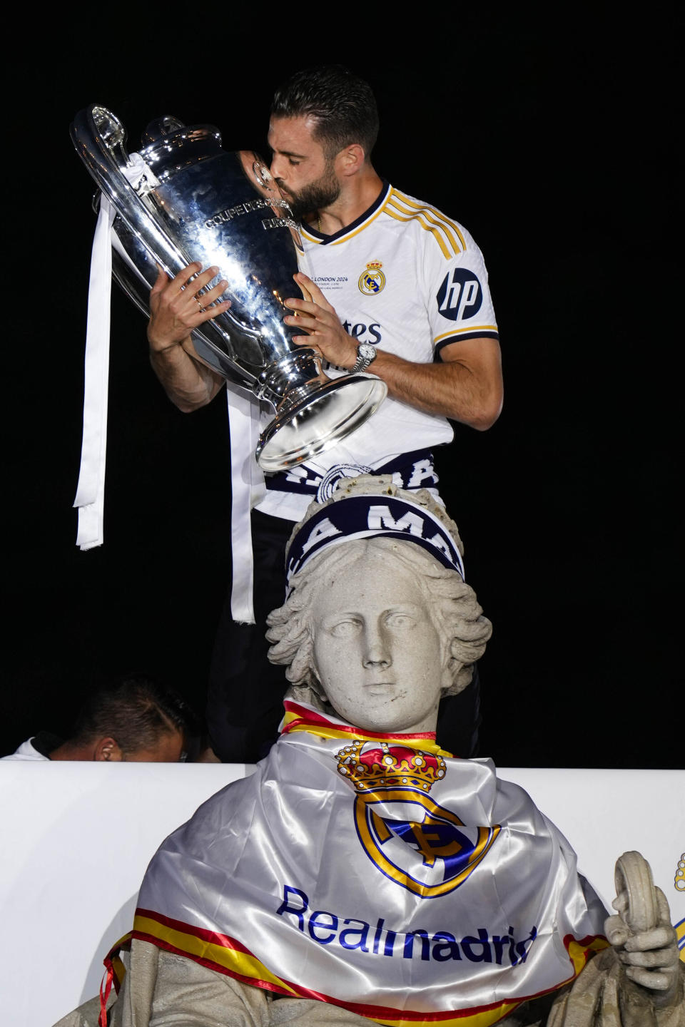 CORRECTS NAME OF PLAYER - Real Madrid's Nacho, kisses the Champions League trophy at the Cibeles square during a trophy paradein Madrid, Spain, Sunday, June 2, 2024. Real Madrid won against Borussia Dortmund 2-0. (AP Photo/Bernat Armangue)