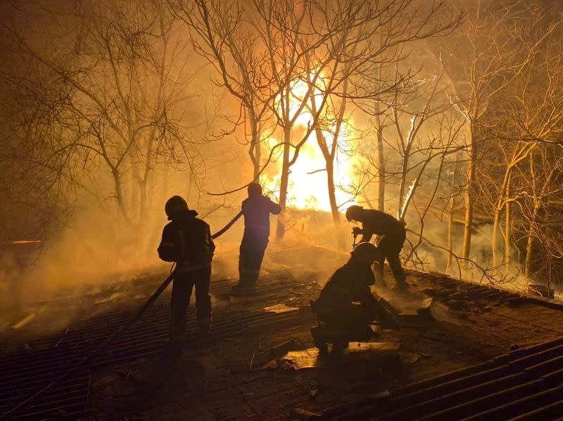 Rescuers work at the site of buildings damaged by shelling in Mykolaiv