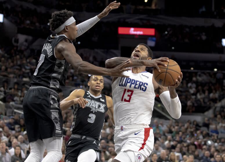 Los Angeles Clippers guard Paul George (13) drives against San Antonio Spurs guard Josh Richardson.