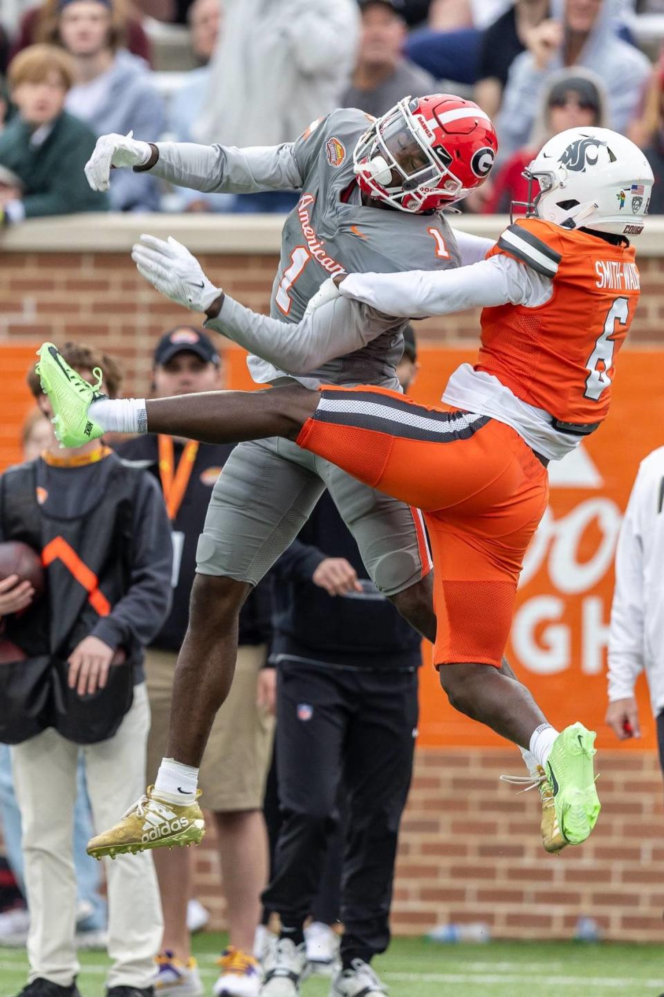 Feb 3, 2024; Mobile, AL, USA; American wide receiver Marcus Rosemy-Jacksaint of Georgia (1) and National defensive back Chau Smith-Wade of Washington State (6) contest a ball during the second half of the 2024 Senior Bowl football game at Hancock Whitney Stadium. Mandatory Credit: Vasha Hunt-USA TODAY Sports