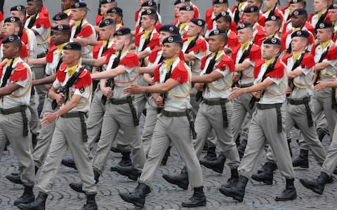 Soldiers of the Franco-German Brigade march during the parade that included German, Spanish and Portuguese troops - Credit: AFP