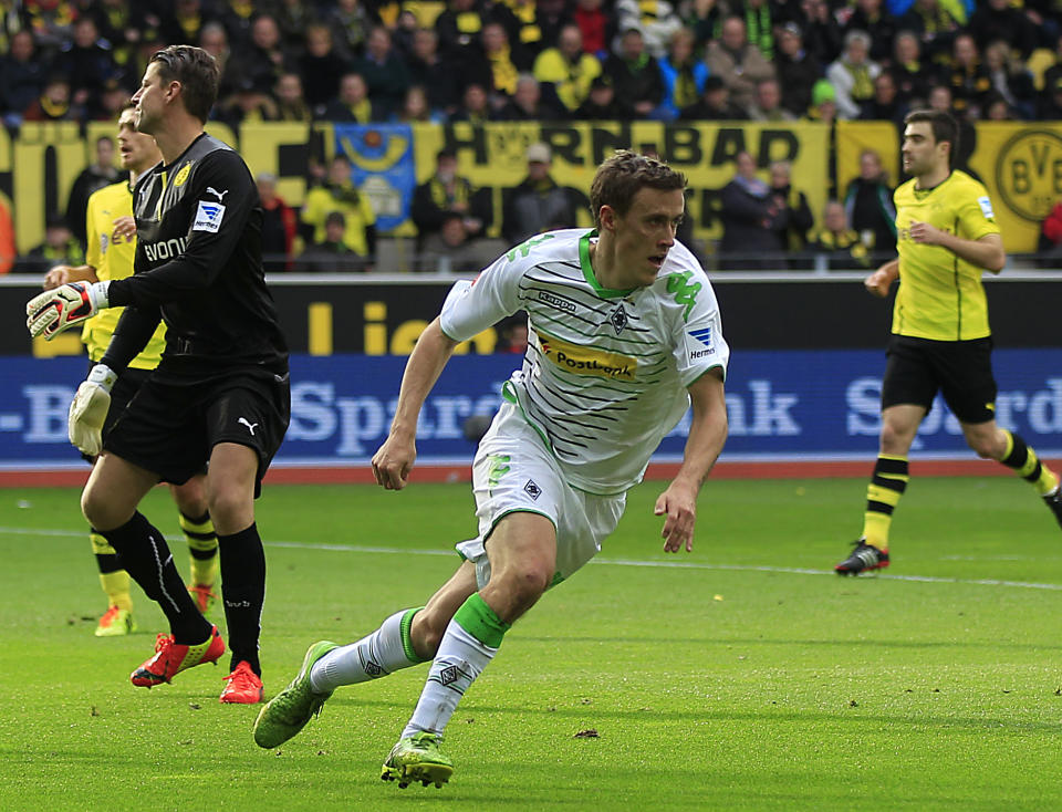 Moenchengladbach's Max Kruse, center, celebrates after scoring during the German first division Bundesliga soccer match between BvB Borussia Dortmund and VfL Borussia Moenchengladbach in Dortmund, Germany, Saturday, March 15, 2014. (AP Photo/Frank Augstein)