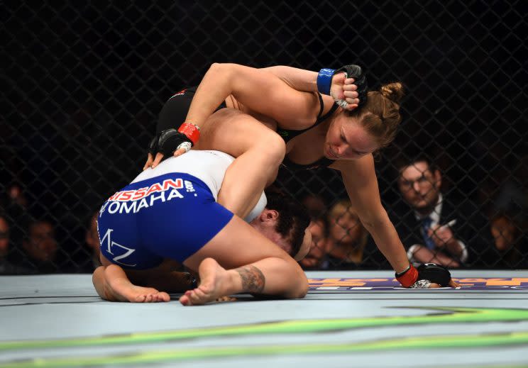 Ronda Rousey sets up an armbar against Cat Zingano at UFC 184. (Getty)