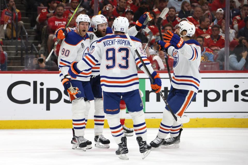 Corey Perry celebrates with teammates after scoring one of the Edmonton Oilers' goals in a 5-3 victory over the Florida Panthers in Stanley Cup final game 5 action on Tuesday. (Bruce Bennett/Getty Images - image credit)