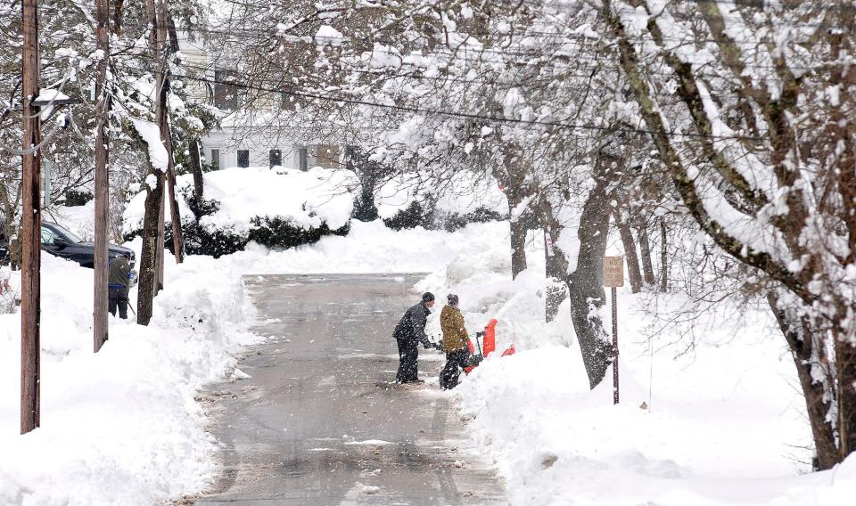 Neighbors dig out a driveway on Rockhill Street in Foxboro, Massachusetts, Monday, March 4, 2019, after the area received well over a foot of snow in an overnight storm.