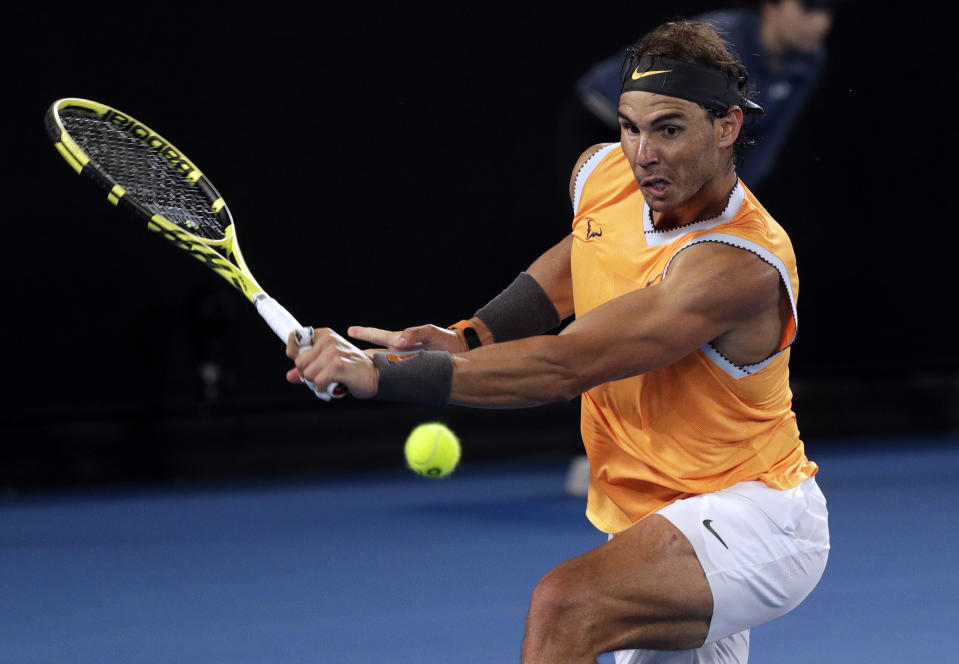 Spain's Rafael Nadal makes a backhand return to Australia's Alex de Minaur during their third round match at the Australian Open tennis championships in Melbourne, Australia, Friday, Jan. 18, 2019. (AP Photo/Kin Cheung)