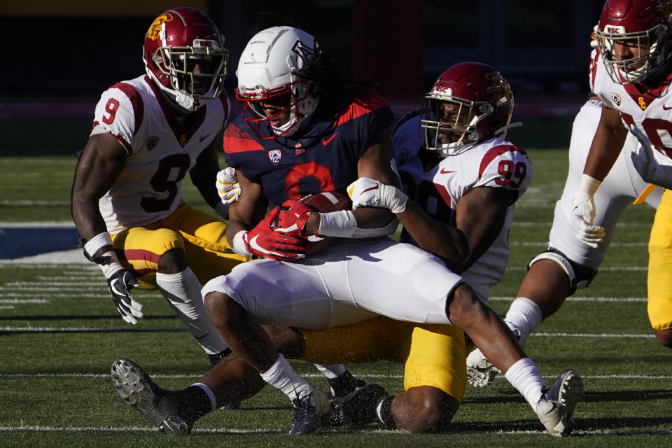 Southern California linebacker Drake Jackson (99) tackles Arizona running back Gary Brightwell (0) in the second half during an NCAA college football game, Saturday, Nov. 14, 2020, in Tucson, Ariz. (AP Photo/Rick Scuteri)