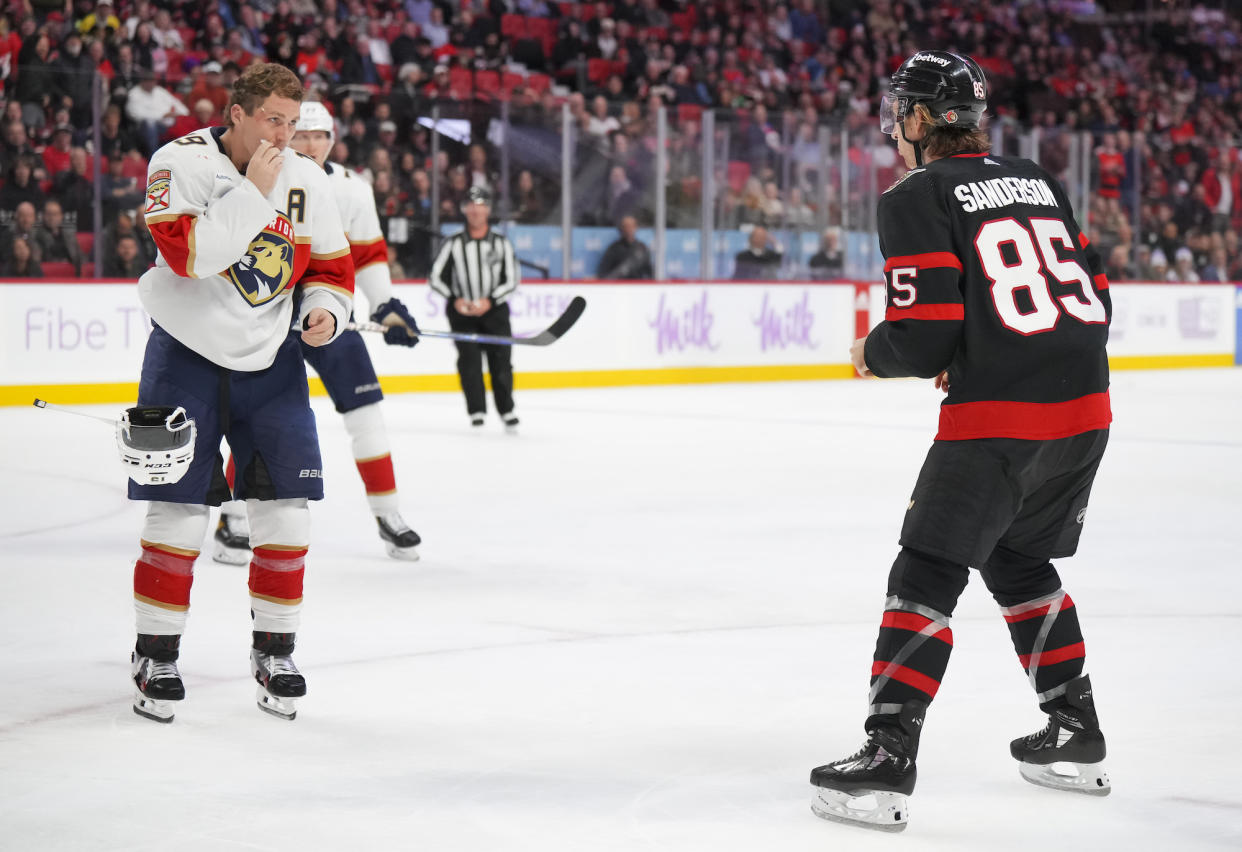 Matthew Tkachuk (L) prepares to fight Jake Sanderson. (André Ringuette/NHLI via Getty Images)