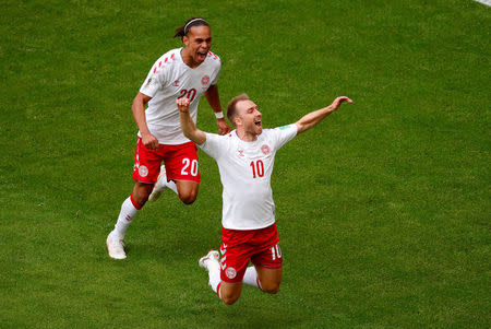 Denmarks Christian Eriksen celebrates with Yussuf Poulsen after scoring their first goal. REUTERS/David Gray