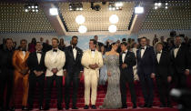 Lewis Pullman, from left, Greg Tarzan Davis, Danny Ramirez, Glen Powell, Jay Ellis, Miles Teller, Jennifer Connelly, Tom Cruise, director Joseph Kosinski, Jerry Bruckheimer, and Jon Hamm depart after the premiere of the film 'Top Gun: Maverick' at the 75th international film festival, Cannes, southern France, Wednesday, May 18, 2022. (AP Photo/Daniel Cole)