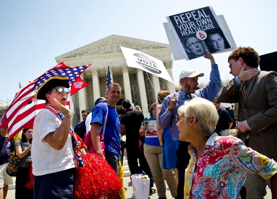 Protesters argue about the Affordable Care Act outside the U.S. Supreme Court on June 28, 2012.