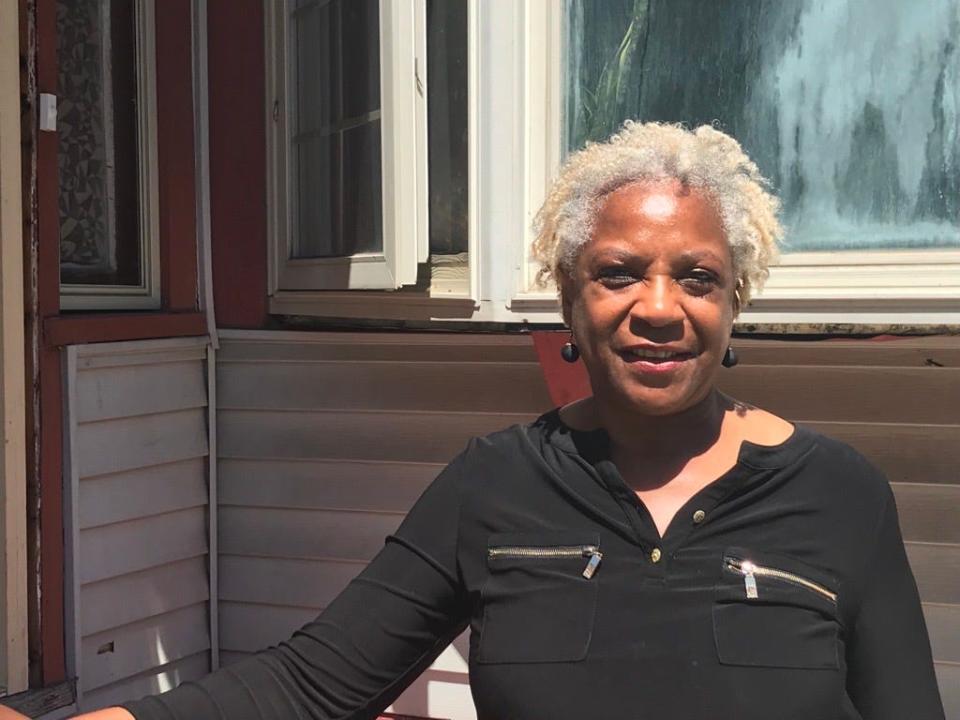 Dorothy York, ACTS Housing vice president of real estate, is pictured in front of a home on West Chambers Street that was purchased and rehabbed through ACTS Housing. York will lead a team to purchase homes with money from the Homeowner Acquisition Fund.