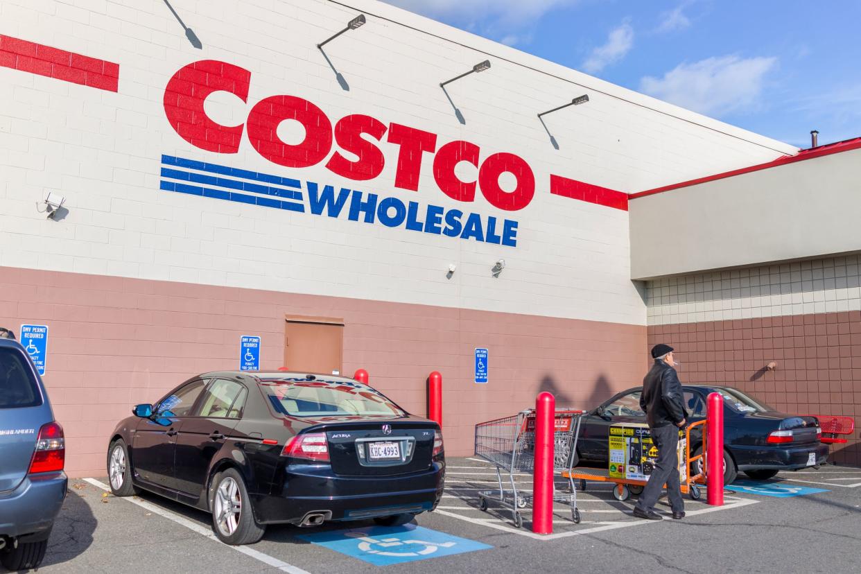 Fairfax, United States - December 3, 2016: Costco wholesale sign on store in Virginia with parked cars and customers walking