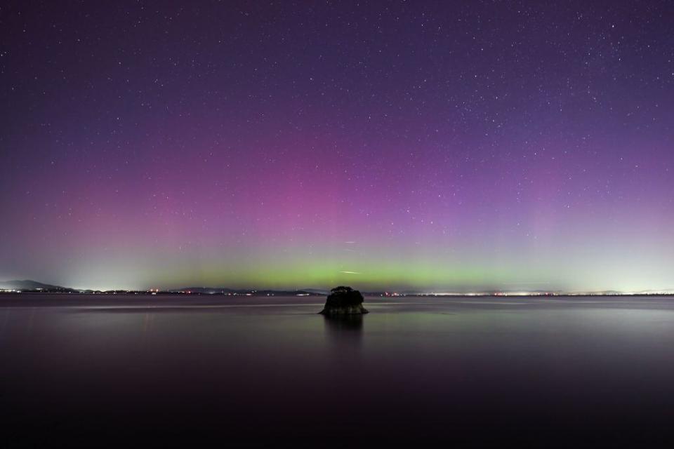 Northern Lights (Aurora Borealis) illuminate the sky of San Francisco North Bay as seen from China Camp Beach in San Rafael, California.