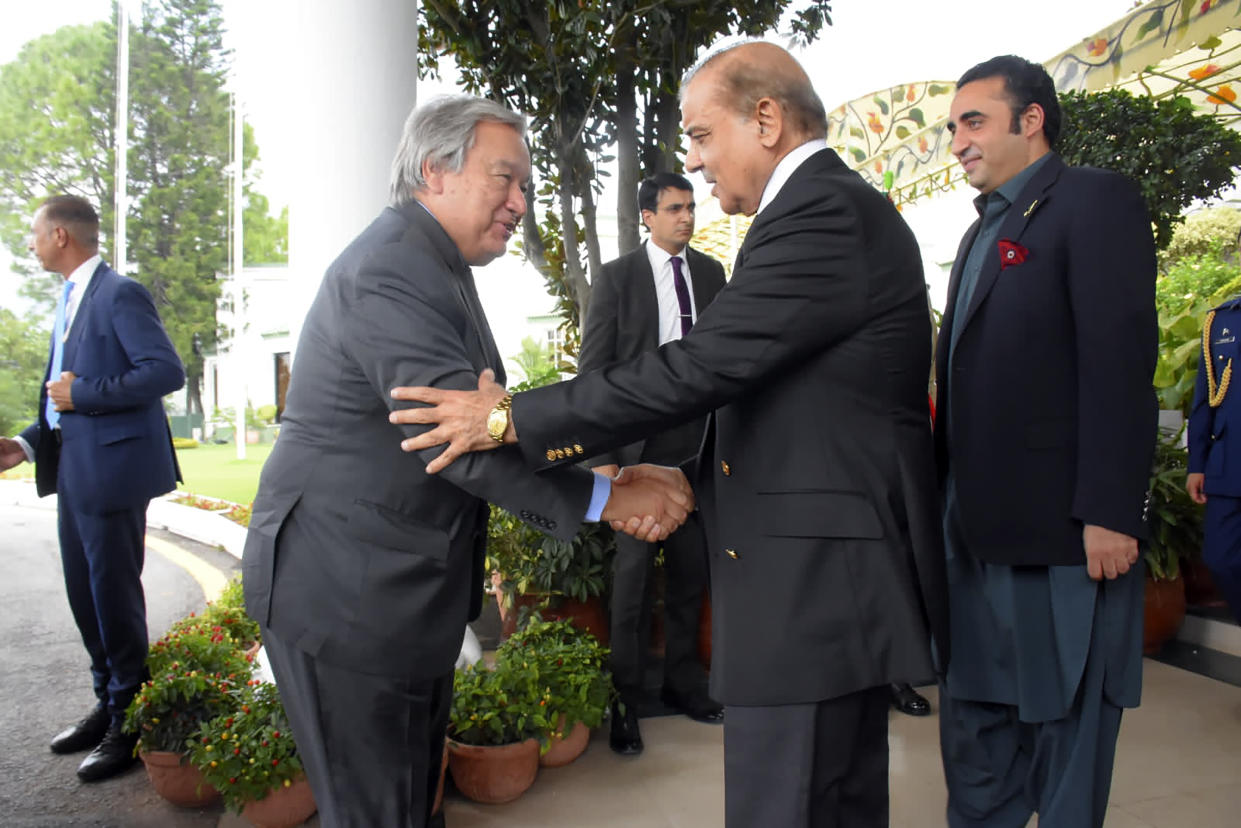 In this handout photo released by Pakistan Prime Minister Office, U.N. Secretary-General Antonio Guterres, second left, shake hand with Pakistan Prime Minister Shahbaz Sharif in Islamabad, Pakistan, Friday, Sept. 9, 2022. Guterres appealed to the world to help Pakistan after arriving in the country Friday to see climate-induced devastation from months of deadly record floods that have left half a million people living in tents under the open sky. (Pakistan Prime Minister Office via AP)