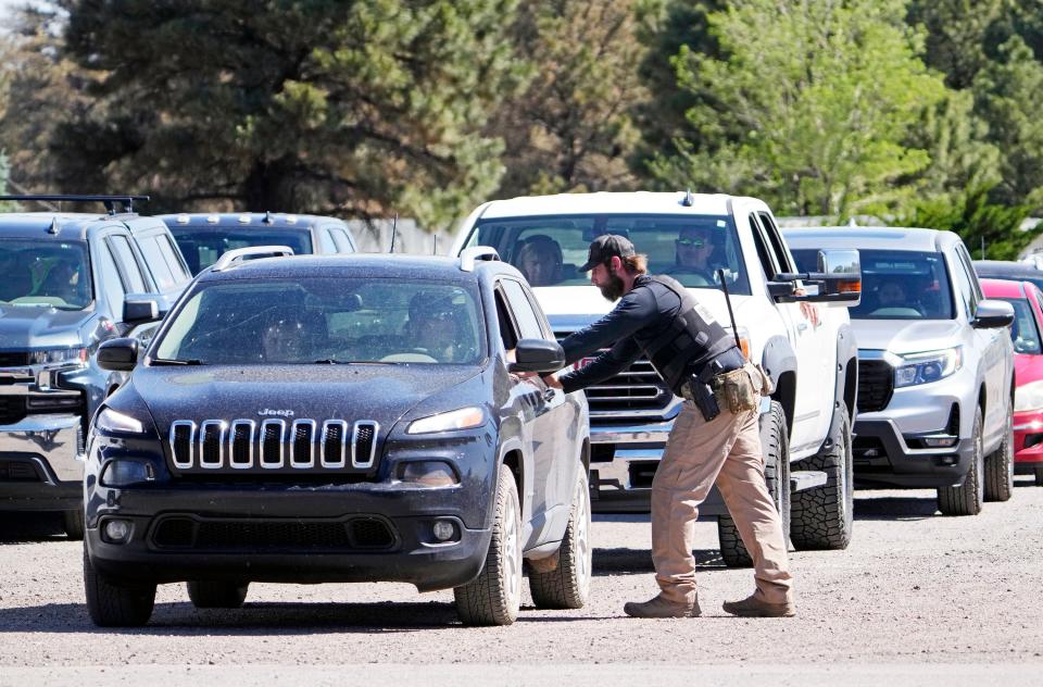 Residents evacuated from communities near the Pipeline Fire wait to be escorted back to their homes by the Coconino County Sheriff's Office north of Flagstaff on June 14, 2022.