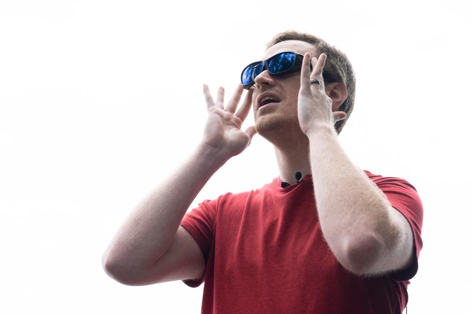 Tim Aepelbacher, 35, of Warren, tries on the EnChroma glasses, which enable him to see a broader range of colors at the Detroit River International Wildlife Center on Tuesday, June 13, 2023. The wildlife center welcomed two individuals with colorblindness to test out the EnChroma glasses for the first time, which enable colorblind people to see colors more clearly and vibrantly. Three EnChroma glasses will be available for visitors at the wildlife center, including one which allows prescription glasses underneath. Aepelbacher has a red-green color deficiency. At home, Aepelbacher's husband Jesse Capp doesn't allow Aepelbacher to cook meat because he typically can't tell the difference between red and brown. Aepelbacher was impressed after trying the glasses on and experiencing the park's view scope. "I see what all the hubbub is about," he said.