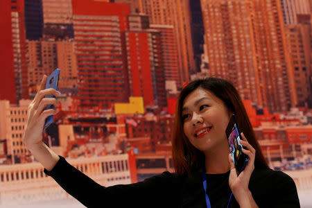 A guest poses with a new Galaxy Note 8 smartphone during the company's launch event in New York City, U.S., August 23, 2017. REUTERS/Brendan McDermid