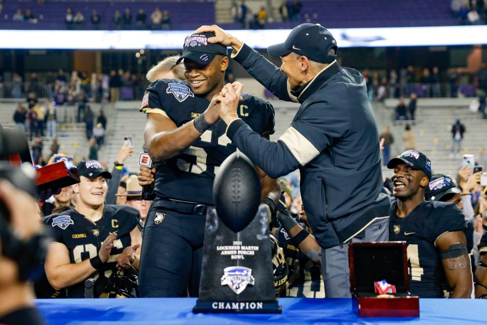 Army coach Jeff Monken celebrates with linebacker Arik Smith (53) after the senior won the MVP award at the Armed Forces Bowl on Dec. 22.