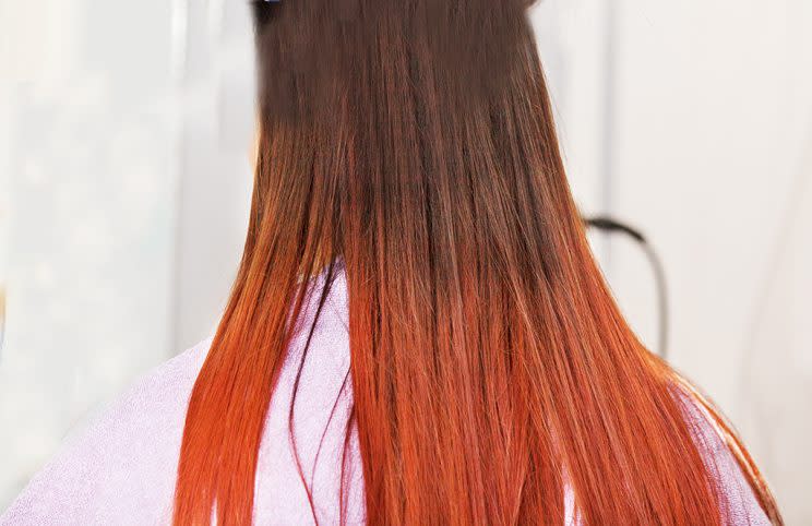 Red hair young woman at hairdresser.