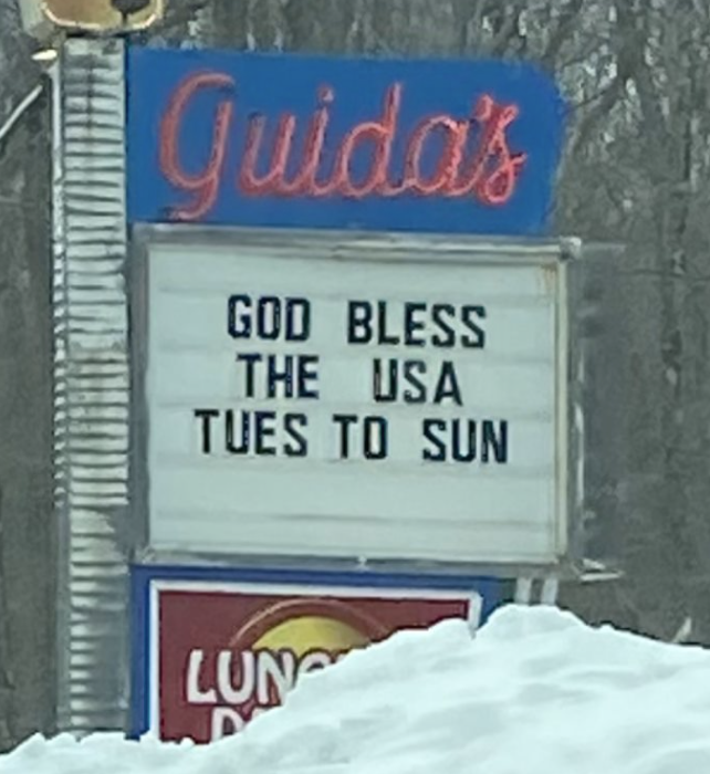 sign reading god bless the usa tues to sun