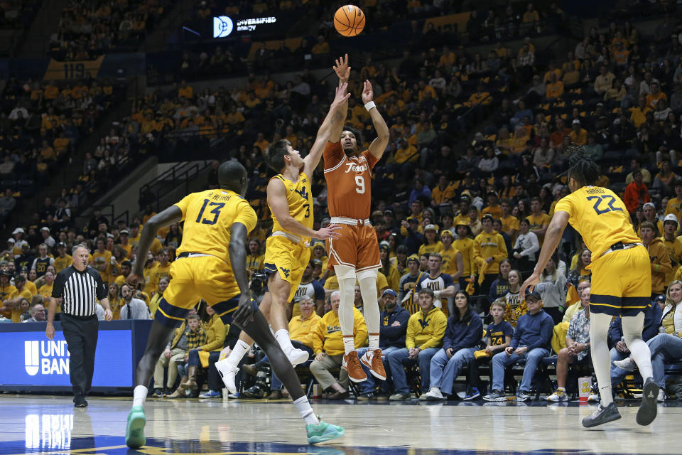 Texas guard Ithiel Horton (9) shoots while defended by West Virginia guard Kerr Kriisa (3) during the first half of an NCAA college basketball game on Saturday, Jan. 13, 2024, in Morgantown, W.Va. (AP Photo/Kathleen Batten)