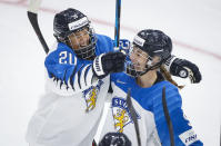 Finland's Nelli Laitinen, right, celebrates her goal with teammate Matilda Nilsson during the first period of an IIHF women's hockey championship game against Canada in Calgary, Alberta, Friday, Aug. 20, 2021. (Jeff McIntosh/The Canadian Press via AP)