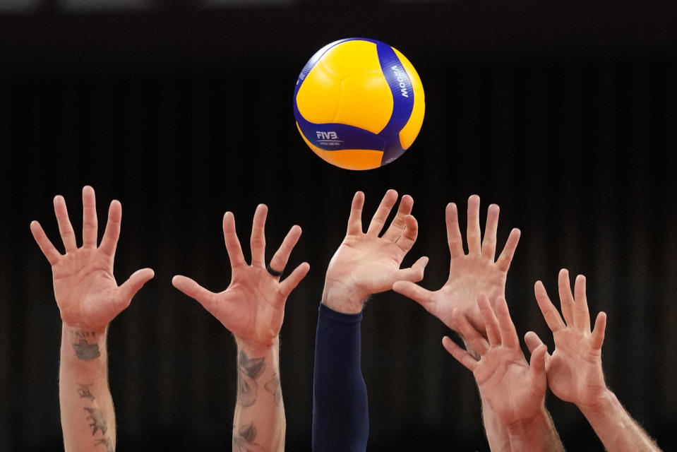 United States's players reach up to block a return ball during a men's volleyball preliminary round pool B match against France, at the 2020 Summer Olympics, Saturday, July 24, 2021, in Tokyo, Japan. (AP Photo/Frank Augstein)