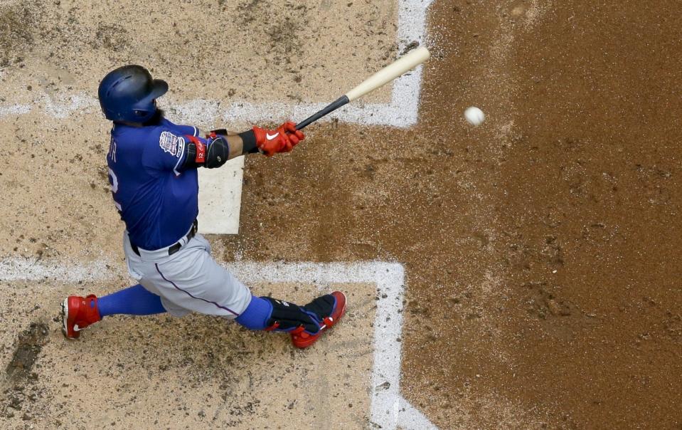 FILE - In this Aug. 11, 2019 file photo, Texas Rangers' Rougned Odor hits a double during the seventh inning of a baseball game against the Milwaukee Brewers, in Milwaukee. A junior team from Venezuela is representing the Latin American region in the Little League Baseball World Series in South Williamsport, Pennsylvania. Venezuelans Ender Inciarte of the Atlanta Braves and Odor helped pay for their trip. (AP Photo/Morry Gash, File)