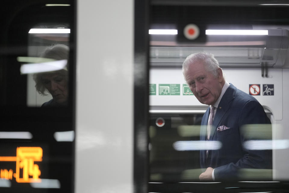 FILE - Britain's King Charles III, with Camilla, the Queen Consort board a train on their way to Hamburg from a train station in Berlin, Friday, March 31, 2023. King Charles III won plenty of hearts during his three-day visit to Germany, his first foreign trip since becoming king following the death of his mother, Elizabeth II, last year. (AP Photo/Markus Schreiber, Pool, File)