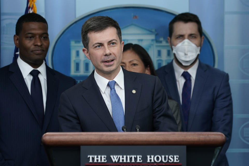 Transportation Secretary Pete Buttigieg, center, speaks during a briefing at the White House in Washington, Monday, May 16, 2022, on the six-month anniversary of the bipartisan infrastructure law. He is joined by, from left, Environmental Protection Agency administrator Michael Regan, Interior Secretary Deb Haaland, and National Economic Council director Brian Deese. (AP Photo/Susan Walsh)