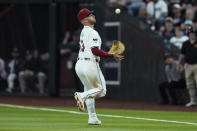 Arizona Diamondbacks first baseman Christian Walker reaches out to make a catch on pop fly hit by Colorado Rockies' Ezequiel Tovar during the fourth inning of a baseball game Thursday, March 28, 2024, in Phoenix. (AP Photo/Ross D. Franklin)