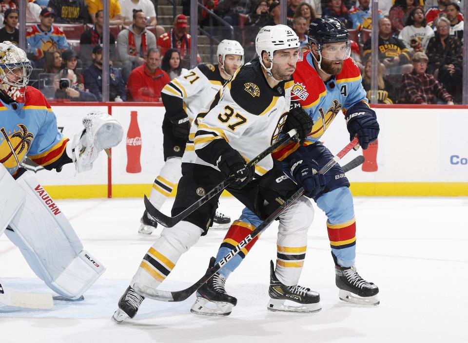 SUNRISE, FL - JANUARY 28: Aaron Ekblad #5 of the Florida Panthers defends against Patrice Bergeron #37 of the Boston Bruins in front of the net during second period action at the FLA Live Arena on January 28, 2023 in Sunrise, Florida. (Photo by Joel Auerbach/Getty Images)