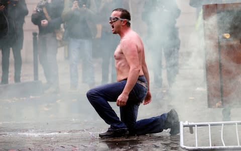 A man wearing goggles as he shouts after being sprayed by the the police water cannon as they protest against rising fuel prices - Credit:  Getty/ Chesnot