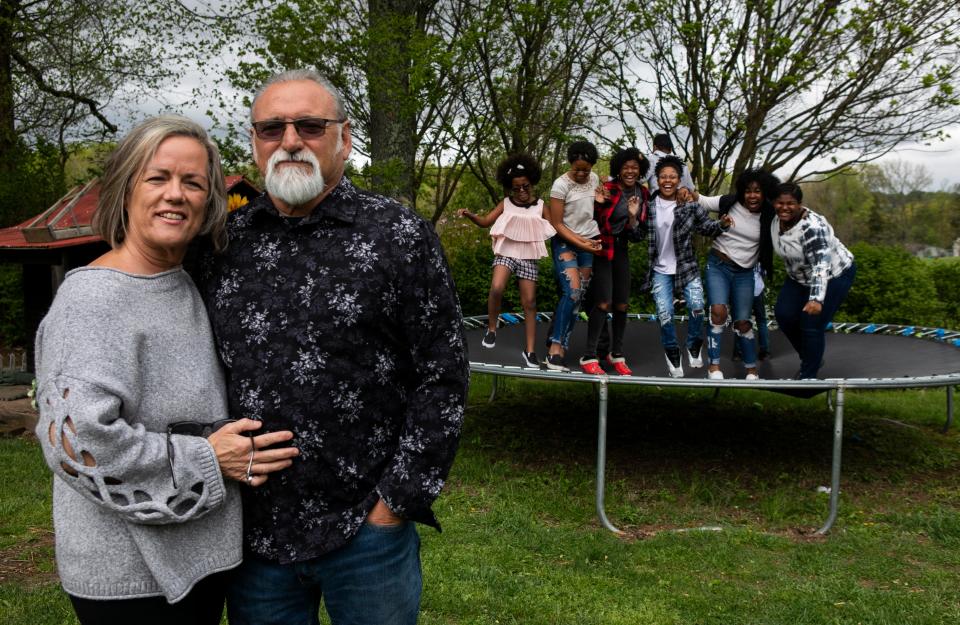 Jeff and Debbie Sherrick stand outside of their homes with their six adopted children and three foster children in the care on May 1, 2023 in Lancaster, Ohio. Jeff and Debbie have been fostering children since 1991 and have around 150 children in their care throughout that time.
