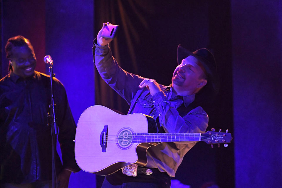 FILE - In this Wednesday, Nov. 13, 2019, file photo, Garth Brooks performs "Dive Bar" at the 53rd annual CMA Awards at Bridgestone Arena in Nashville, Tenn. Add Garth Brooks to the lineup of entertainers at the inauguration of President-elect Joe Biden. Brooks, who joins Lady Gaga and Jennifer Lopez among others, performed during the inaugural celebration of President Barack Obama in 2009. He turned down a chance to play for President Donald Trump in 2017, citing a scheduling conflict. (AP Photo/Mark J. Terrill, File)