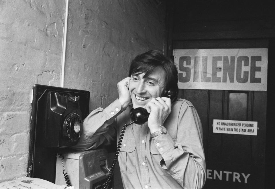 Hill back-stage during a break in rehearsals for Tonight's the Night at the Talk of the Town Theatre, ringing his wife Annie on the stage door telephone, 1971