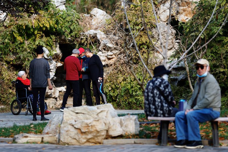 Elderly people rest and chat at a park in Beijing