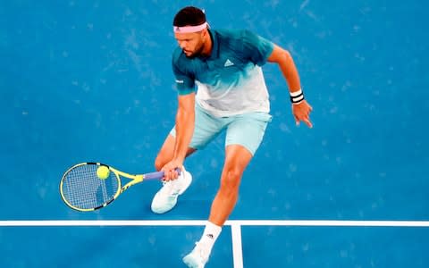 France's Jo-Wilfried Tsonga hits a return against Serbia's Novak Djokovic during their men's singles match on day four of the Australian Open tennis tournament in Melbourne on January 17, 2019 - Credit: AFP