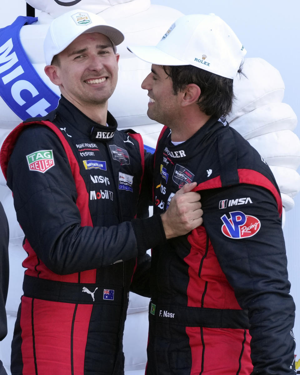 Matt Campbell, left, of Australia, and Felipe Nasr, of Brazil, celebrate in Victory Lane after winning the Rolex 24-hour auto race at Daytona International Speedway, Sunday, Jan. 28, 2024, in Daytona Beach, Fla. (AP Photo/John Raoux)