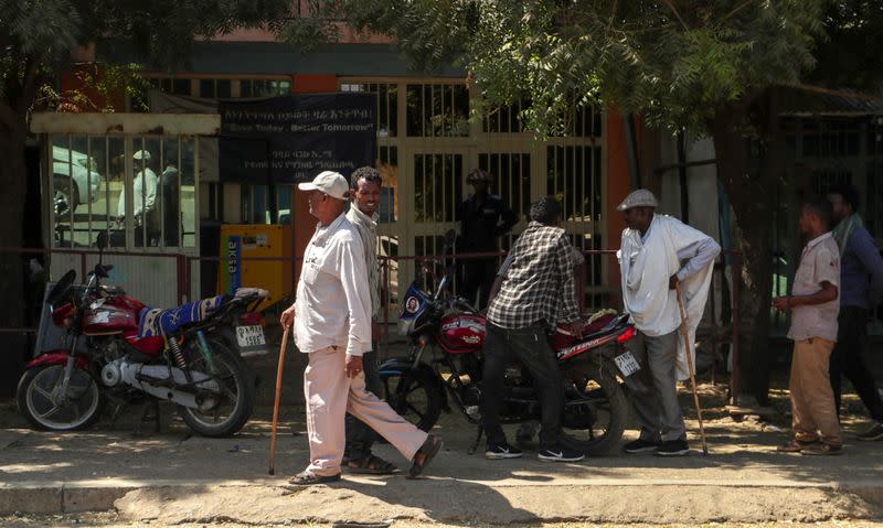 Men walk along a street in Dansha town in Tigray Region