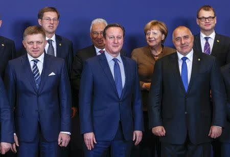 Slovakian Prime Minister Robert Fico, British Prime Minister David Cameron, German Chancellor Angela Merkel and Bulgarian Prime Minister Boyko Borisov take part in a group photo with other EU countries leaders at a European Union leaders summit addressing the talks about the so-called Brexit and the migrants crisis, in Brussels, Belgium, February 18, 2016. REUTERS/Yves Herman