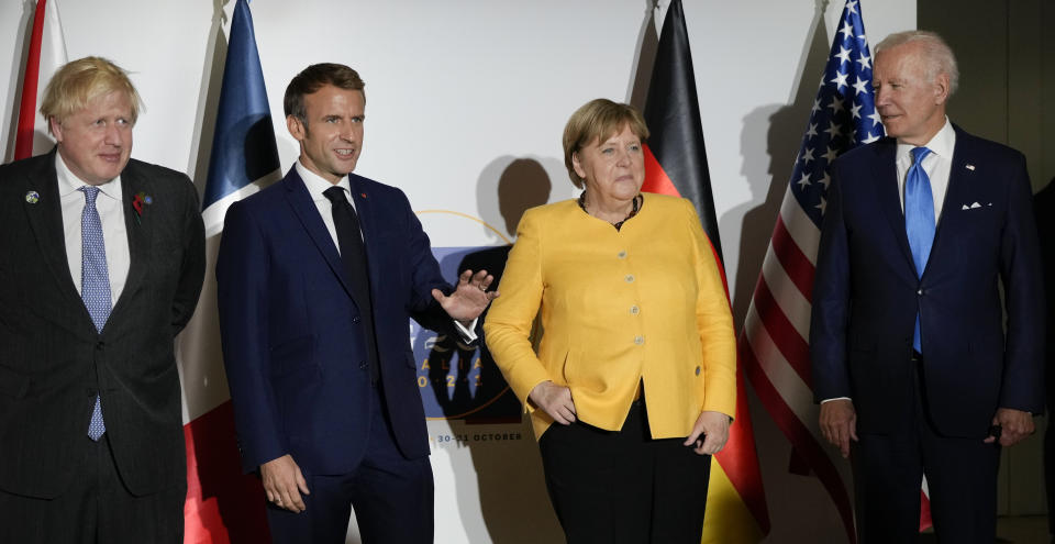 British Prime Minister Boris Johnson, French President Emmanuel Macron, German Chancellor Angela Merkel, and U.S. President Joe Biden, from left, pose for the media prior to a meeting at the La Nuvola conference center for the G20 summit in Rome, Saturday, Oct. 30, 2021. The two-day Group of 20 summit is the first in-person gathering of leaders of the world's biggest economies since the COVID-19 pandemic started. (AP Photo/Kirsty Wigglesworth, Pool)